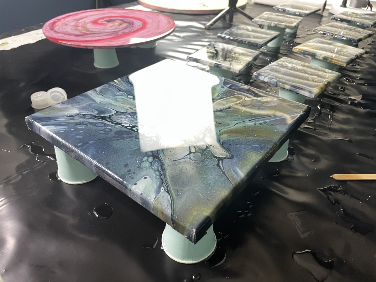Recently resined acrylic pour paintings still wet