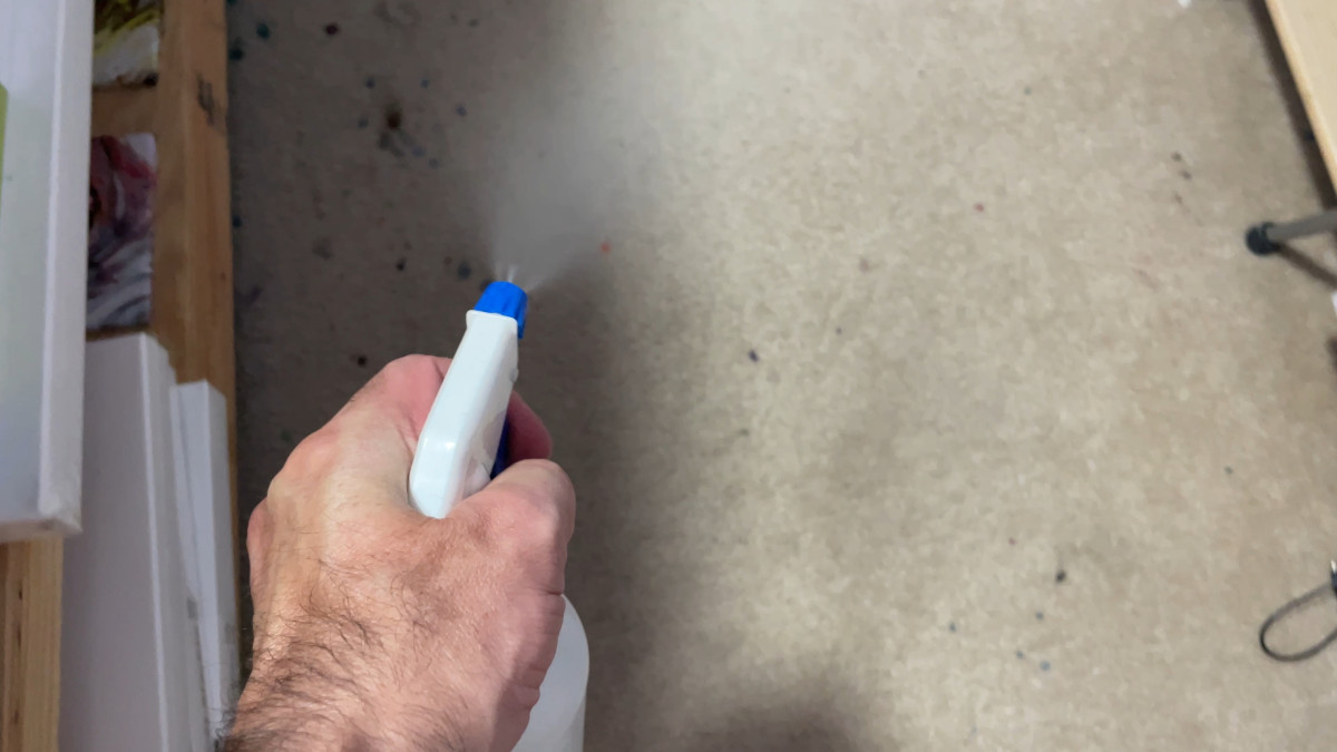 spraying floor with water